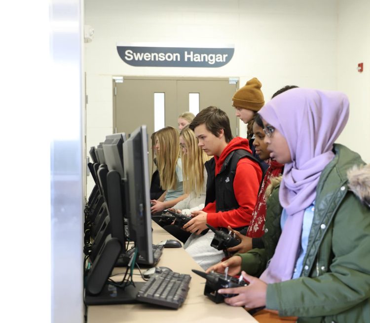 Group of students flying drones with simulator on Aerospace campus