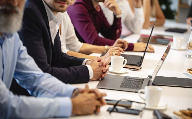 Businesspeople Seated Side by Side at Conference Table